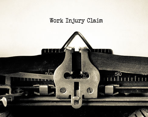 Typewriter typing "Work Injury Claim"